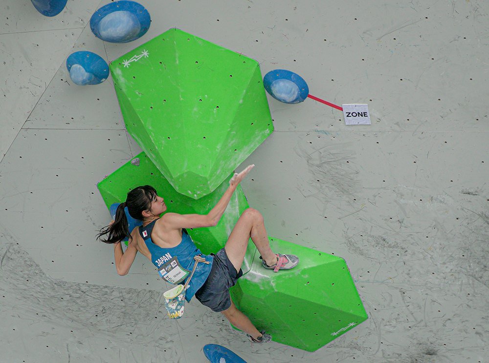 A climber on SM Climb hexagonal volumes
