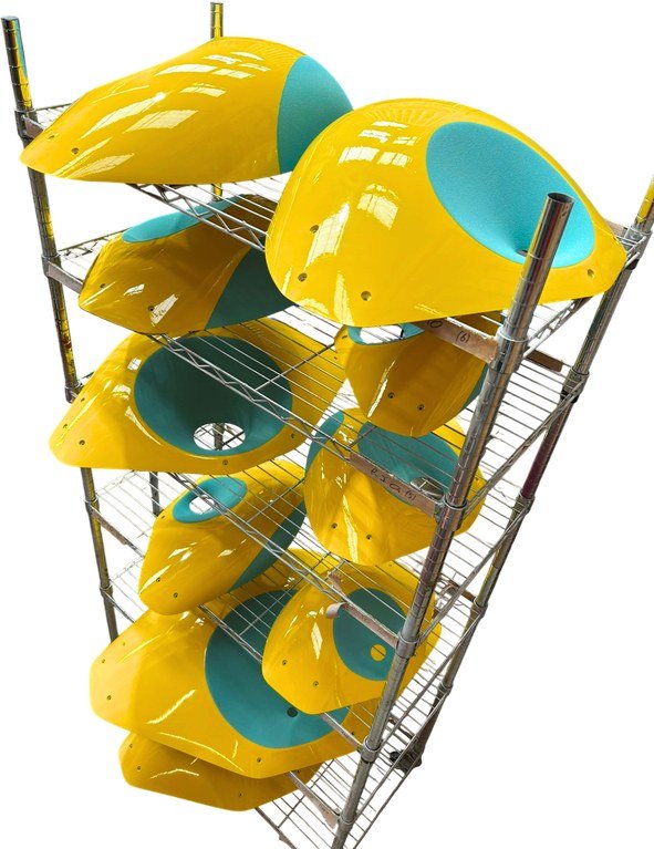 SUPR BORIS dual-texture fibreglass macros in yellow and teal on a rack